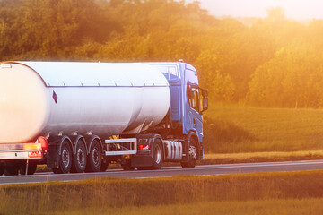 Gasoline tanker truck driving on asphalt highway