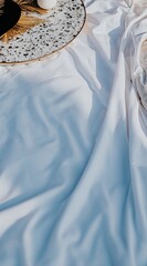White cloth draped over a surface, with a decorative platter and candles