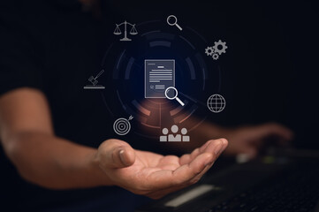 Corporate governance, regulatory compliance, and policy management concept. A businessman's hand holds a virtual interface with a central document icon surrounded by legal, audit, and process symbols