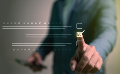 Close up of a businessman's finger checking a box on a digital to-do list. This visual represents productivity, effective planning, task completion, and achieving goals in a business project