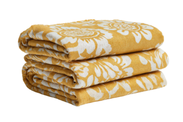Stacked mustard yellow blankets with a floral motif