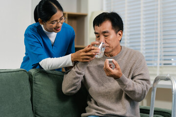 Therapist woman taking care and giving a glass of water and taken daily medicine or vitamin supplements, elderly healthcare.