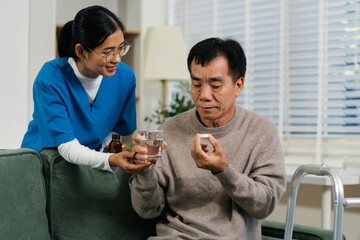 Therapist woman taking care and giving a glass of water and taken daily medicine or vitamin...