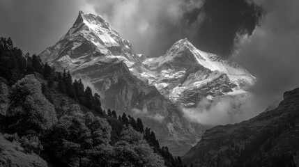 Majestic snow-capped peaks pierce a dramatic sky