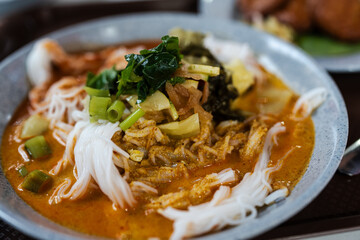 Khanom Jeen Namya Kati with fresh and pickled vegetables, a famous Thai food