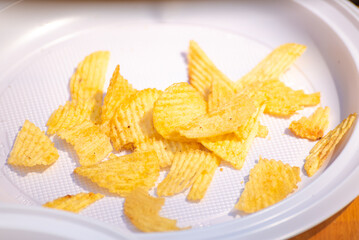 Ruffled potato chips on a white plastic plate, Salty Snack