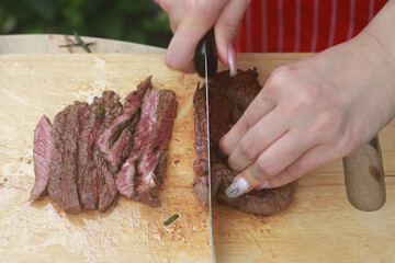 The steak is being cut with a knife.