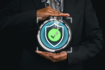 Businessman holding a digital insurance icon, representing security and assurance in modern...
