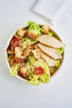 Enjoy a flavorful chicken breast caesar salad featuring tender slices of chicken, crisp romaine lettuce, juicy tomatoes, and crunchy croutons, all mixed with savory dressing