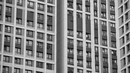 empty glass windows of a modern building with a reflection of the sky in the glass