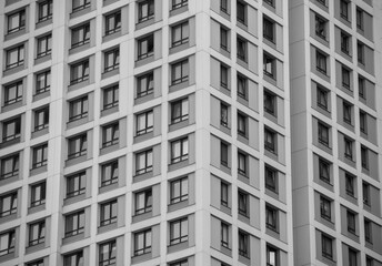 empty glass windows of a modern building with a reflection of the sky in the glass