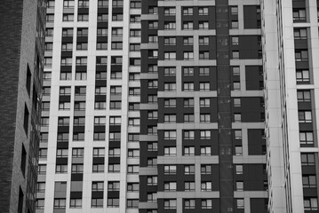 empty glass windows of a modern building with a reflection of the sky in the glass