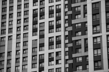 empty glass windows of a modern building with a reflection of the sky in the glass