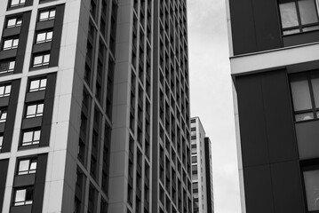 empty glass windows of a modern building with a reflection of the sky in the glass