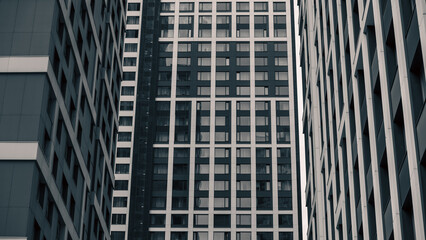 empty glass windows of a modern building with a reflection of the sky in the glass