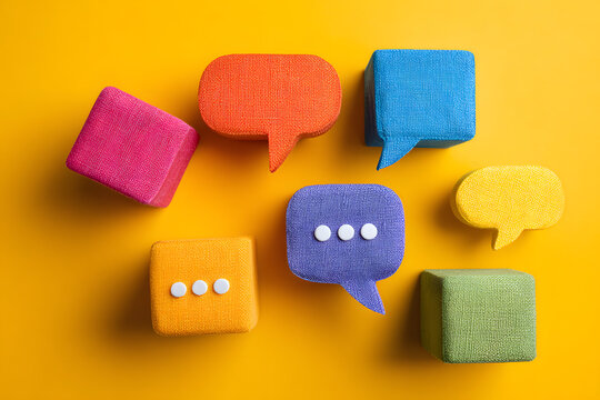 The concept of inclusive language is illustrated by olorful cubes and speech bbbles