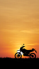 Silhouette of a Motorcycle at Sunset: A captivating silhouette of a motorcycle against a breathtaking sunset backdrop, set on the open road, inspiring freedom and adventure. 
