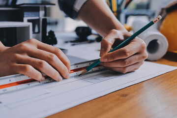 Construction and structure concept of engineer working drawing on blueprint meeting for project...