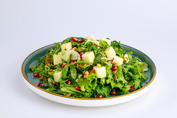 Plate of Fresh Vegetable Salad with Pomegranate Seeds and Cheese Cubes