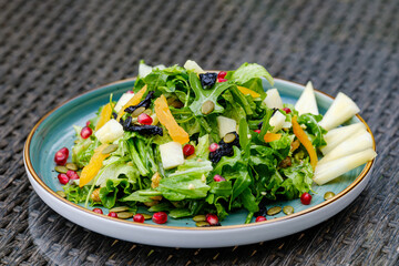 Plate of Fresh Vegetable Salad with Pomegranate Seeds and Cheese Cubes