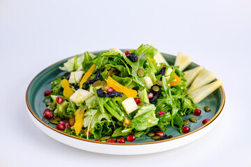 Plate of Fresh Vegetable Salad with Pomegranate Seeds and Cheese Cubes