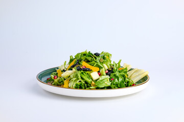 Plate of Fresh Vegetable Salad with Pomegranate Seeds and Cheese Cubes