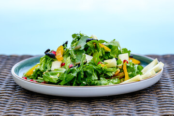 Plate of Fresh Vegetable Salad with Pomegranate Seeds and Cheese Cubes