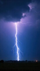 Dramatic shot of a powerful lightning bolt striking during a summer thunderstorm, illuminating the dark sky with intense light and energy , dark, natural phenomenon