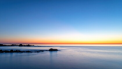Fototapeta premium Blue hour wash with faint coastal glow on horizon clean background plane representing tranquil sky scene suitable for calm atmospheric design