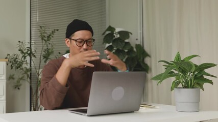 Asian man attending an online business meeting while working from home.4k