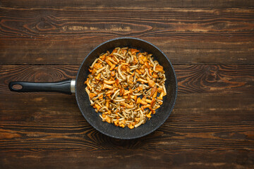 Delicious mushroom stir-fry prepared in a skillet on a wooden table