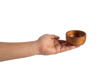 Small round wooden cup in hand on transparent background