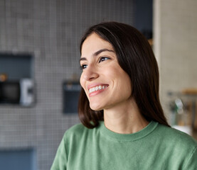Fototapeta premium Portrait of a young woman drinkng coffee in kitchen