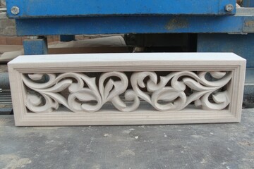 Carved wood panel, light beige, intricate design