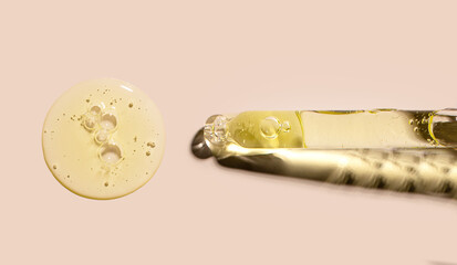 pipette drop of serum test on a beige background