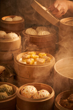 A steamer filled with Chinese breakfast siomai, wafting smoke