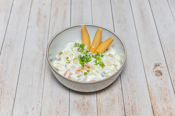 Russian salad with chunks of Galician octopus, potatoes, roasted red peppers, and green olives, dressed with a light vinaigrette.