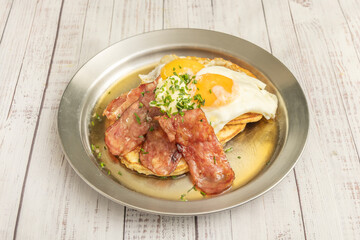   egg-soaked brioche bread with bacon and maple syrup for brunch