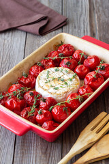 Baked brie cheese with tomatoes and thyme. Healthy food. Vegetarian food.