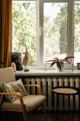 Armchair with pillows and table in a cozy apartment