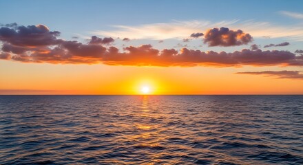 Obraz premium A beautiful sunset over the ocean with clouds and orange sky and sun reflection on water surface