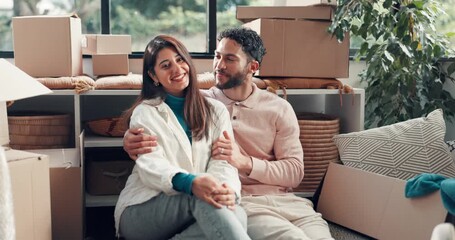 Real estate, face and couple with hug in new home for moving in, mortgage success or achievement. Relocation, happy people or embrace with support for property investment, security and boxes on floor