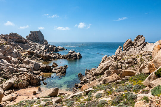Rocky bay with turquoise sea and wildflowers at Capo Testa Sardinia