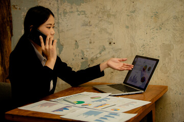 Professional businesswoman working at office desk with laptop, analyzing financial data, showcasing leadership, motivation, corporate expertise, and entrepreneurial confidence.