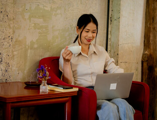 Professional businesswoman working at office desk with laptop, analyzing financial data, showcasing leadership, motivation, corporate expertise, and entrepreneurial confidence.