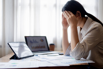 Confident businesswoman working at desk with computer in office, smiling while focusing on tasks, symbolizing success, motivation, persistence, and professionalism.
