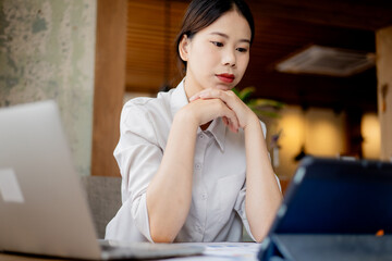 Professional businesswoman working at office desk with laptop, analyzing financial data, showcasing leadership, motivation, corporate expertise, and entrepreneurial confidence.
