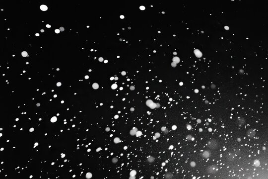 Snow falling on a black background