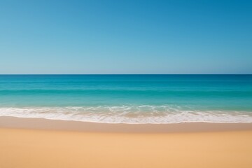 Fototapeta premium Calm turquoise ocean waves gently lap onto a pristine golden sand beach under a clear blue sky