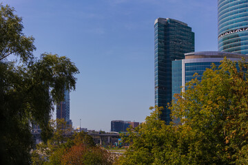 High-rise buildings and skyscrapers on a sunny summer day. Sunbeams and glare on the buildings